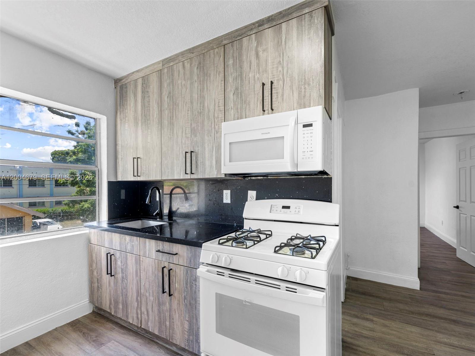 500 Southwest 8th Street Miami, FL 33130 - Photo 19 of 33 a kitchen with appliances a sink and a stove