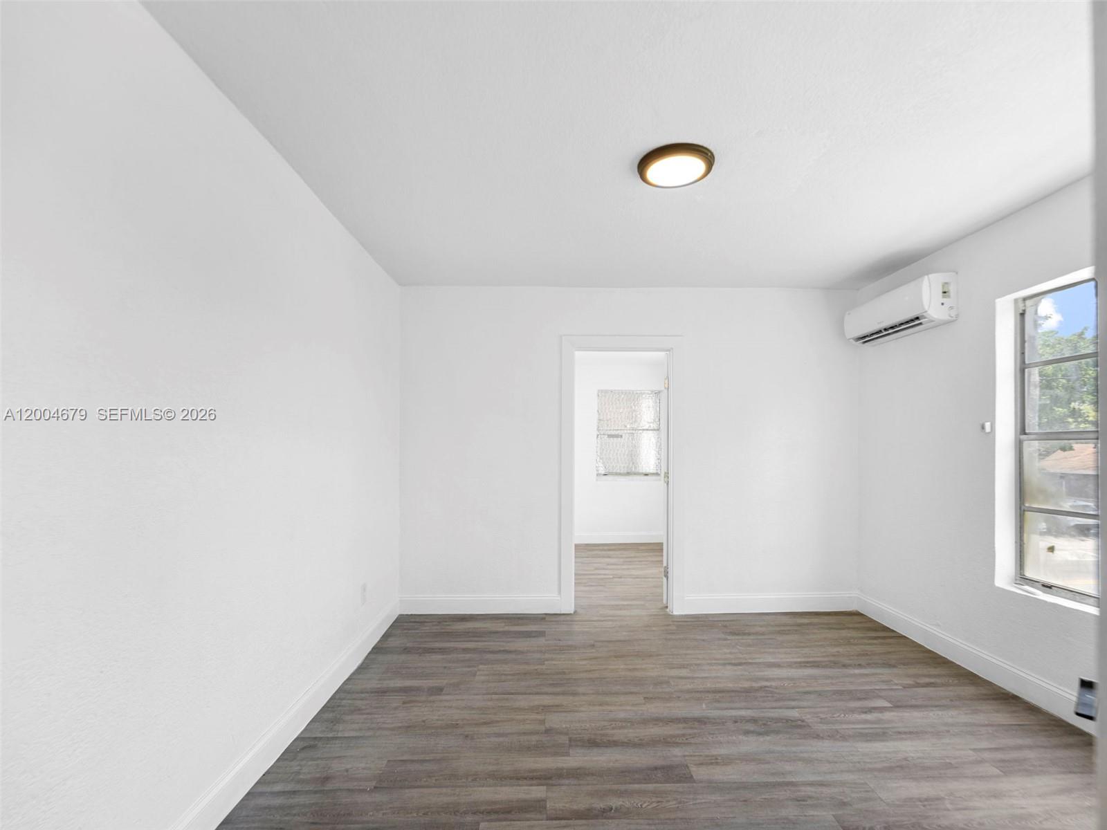 500 Southwest 8th Street Miami, FL 33130 - Photo 21 of 33 a view of a livingroom with wooden floor and window