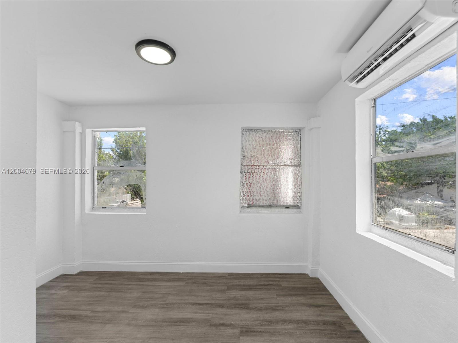 500 Southwest 8th Street Miami, FL 33130 - Photo 23 of 33 a view of an empty room with wooden floor and a window