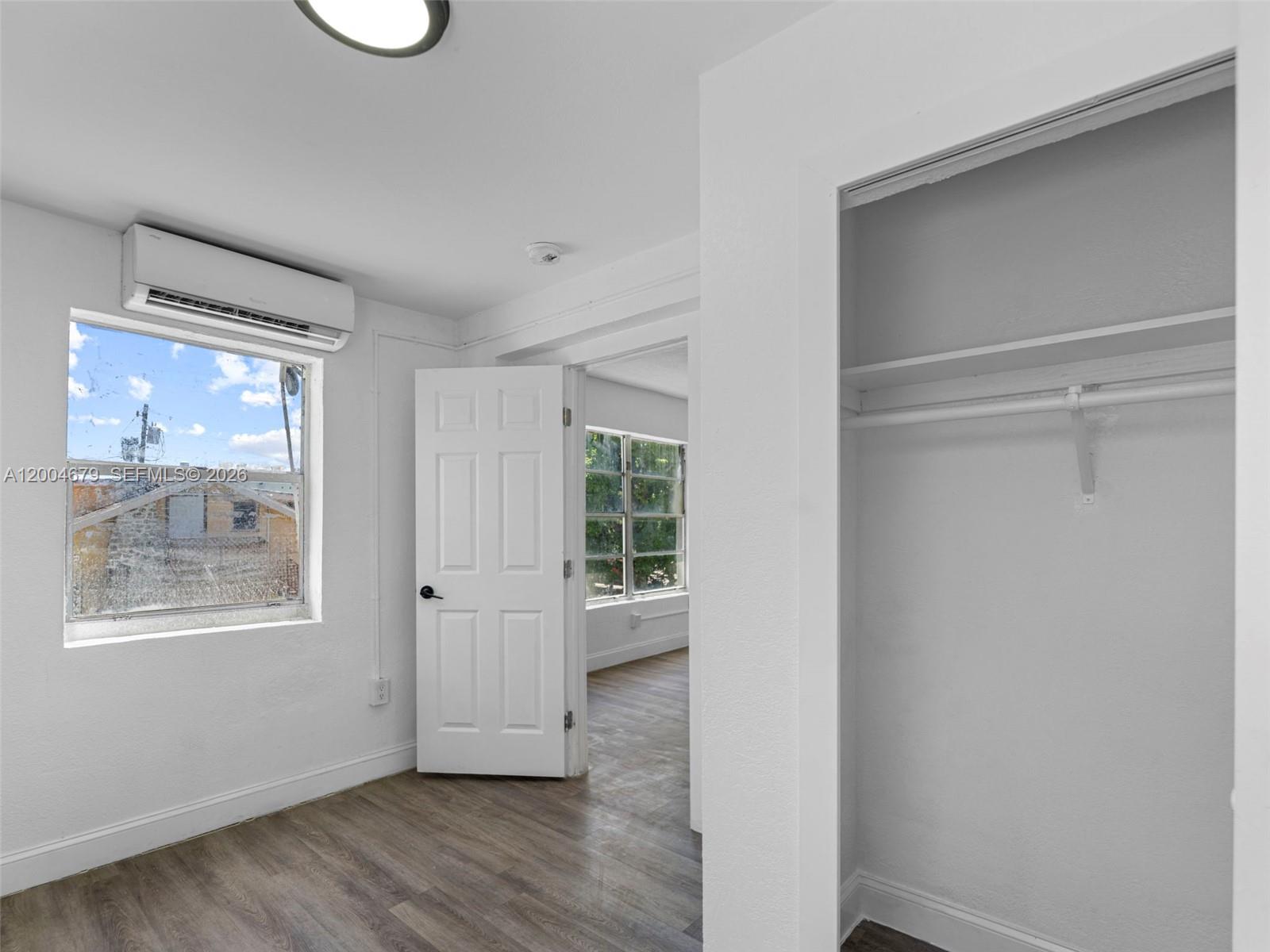 500 Southwest 8th Street Miami, FL 33130 - Photo 25 of 33 a view of an empty room with wooden floor and a window