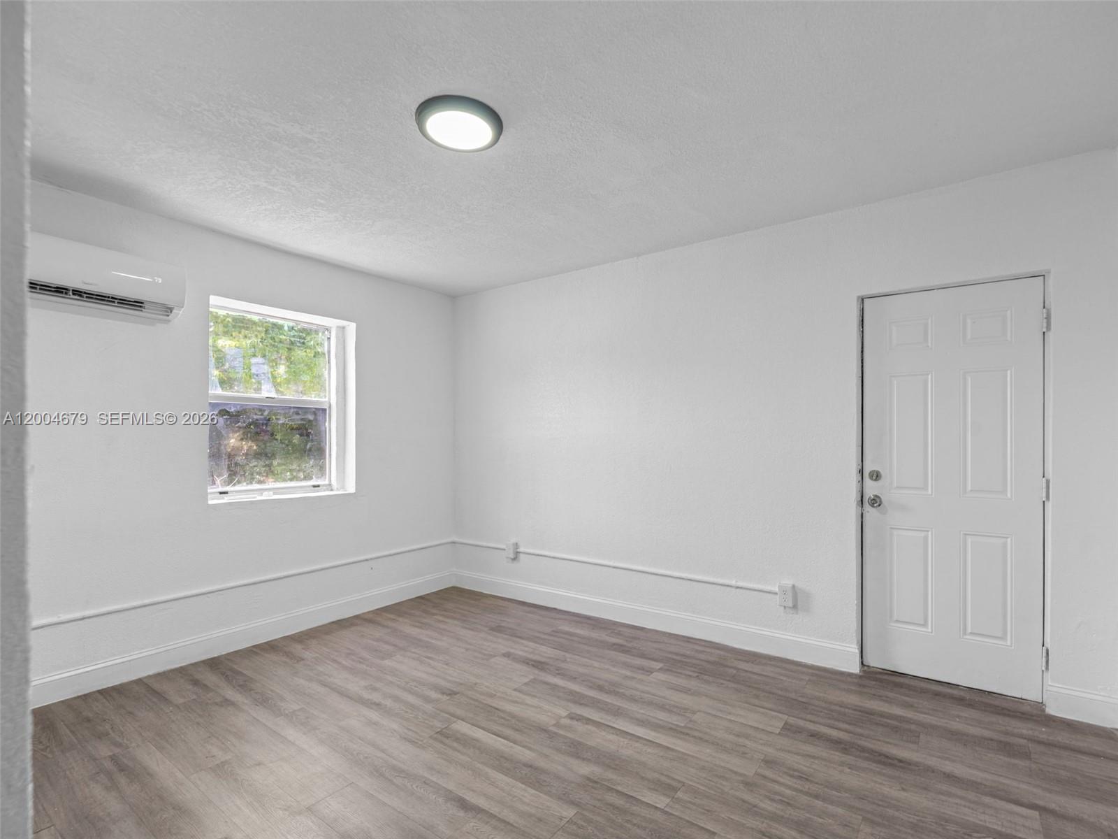 500 Southwest 8th Street Miami, FL 33130 - Photo 26 of 33 an empty room with wooden floor and windows