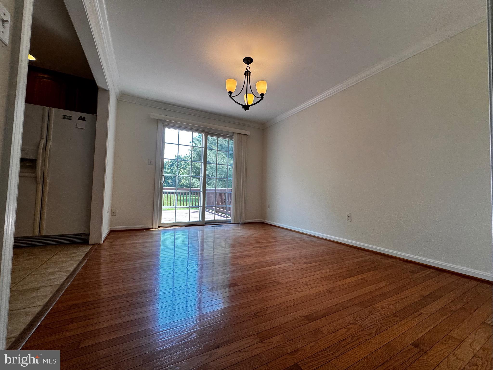 2653 Sandymount Road Finksburg, MD 21048 - Photo 12 of 68 a view of an empty room with wooden floor and a window