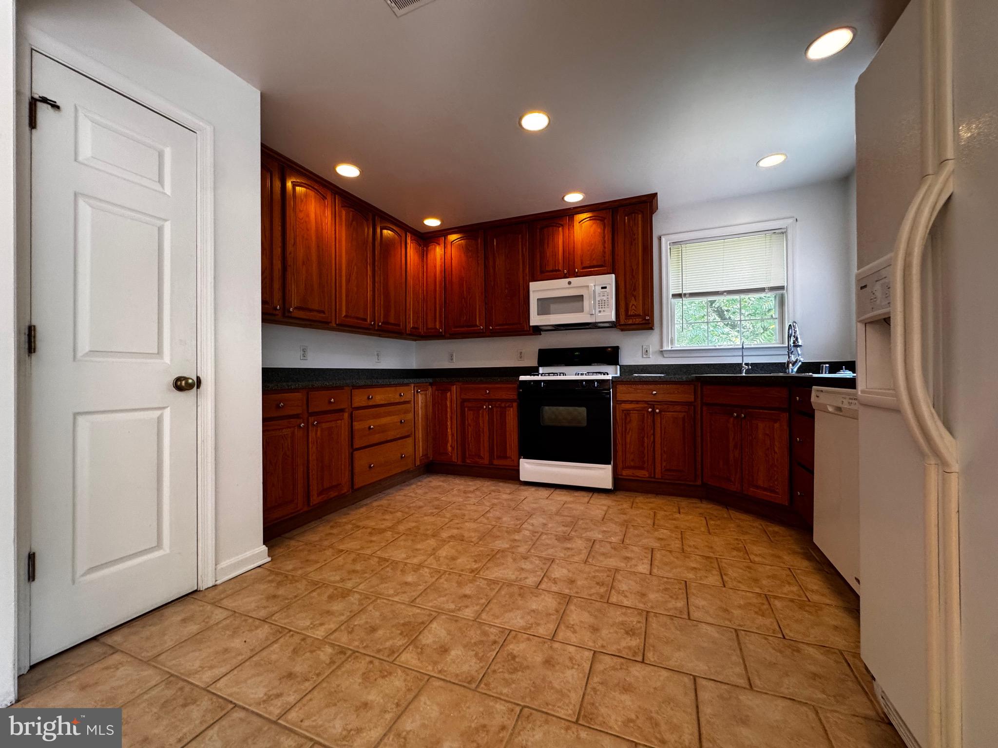 2653 Sandymount Road Finksburg, MD 21048 - Photo 14 of 68 a kitchen with stainless steel appliances granite countertop a stove sink and cabinets