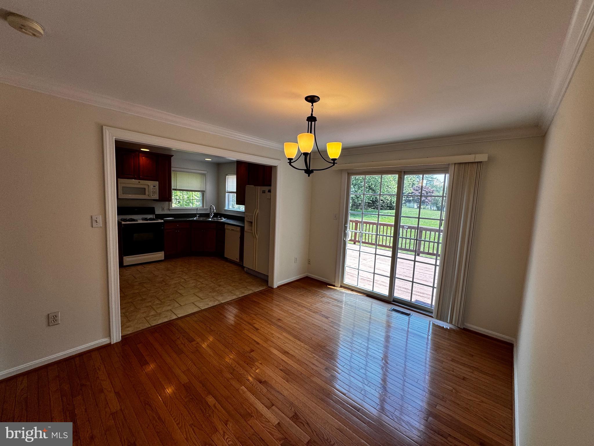 2653 Sandymount Road Finksburg, MD 21048 - Photo 16 of 68 a view of a room with wooden floor and a kitchen