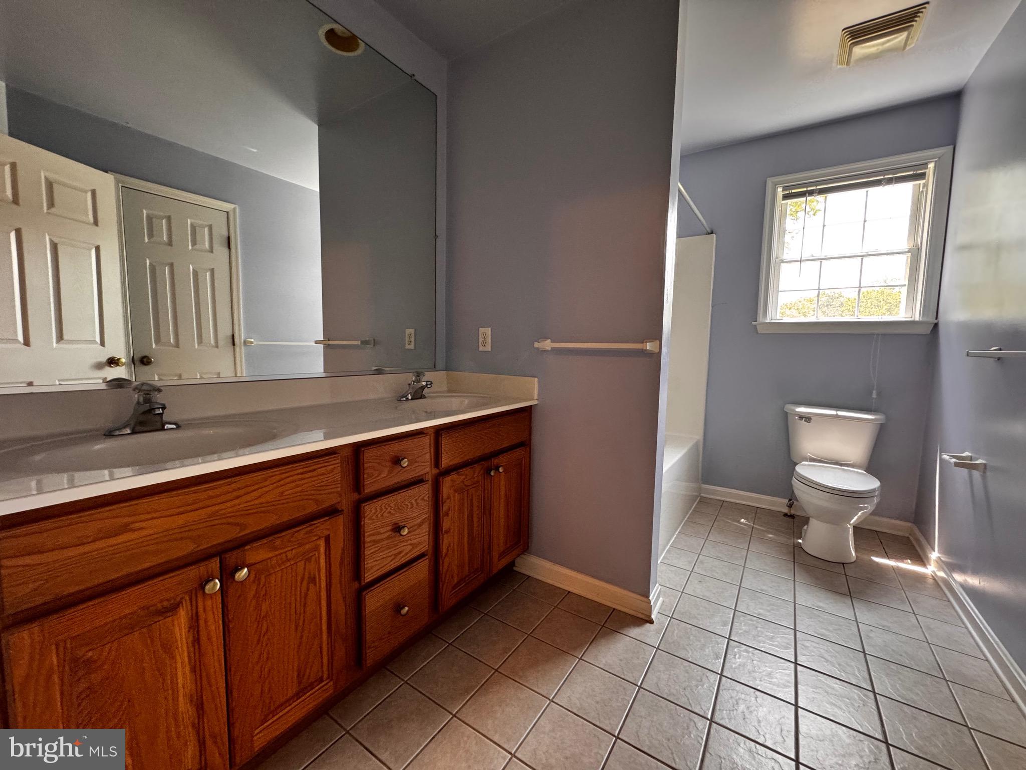 2653 Sandymount Road Finksburg, MD 21048 - Photo 30 of 68 a spacious bathroom with a double vanity sink a toilet and a window