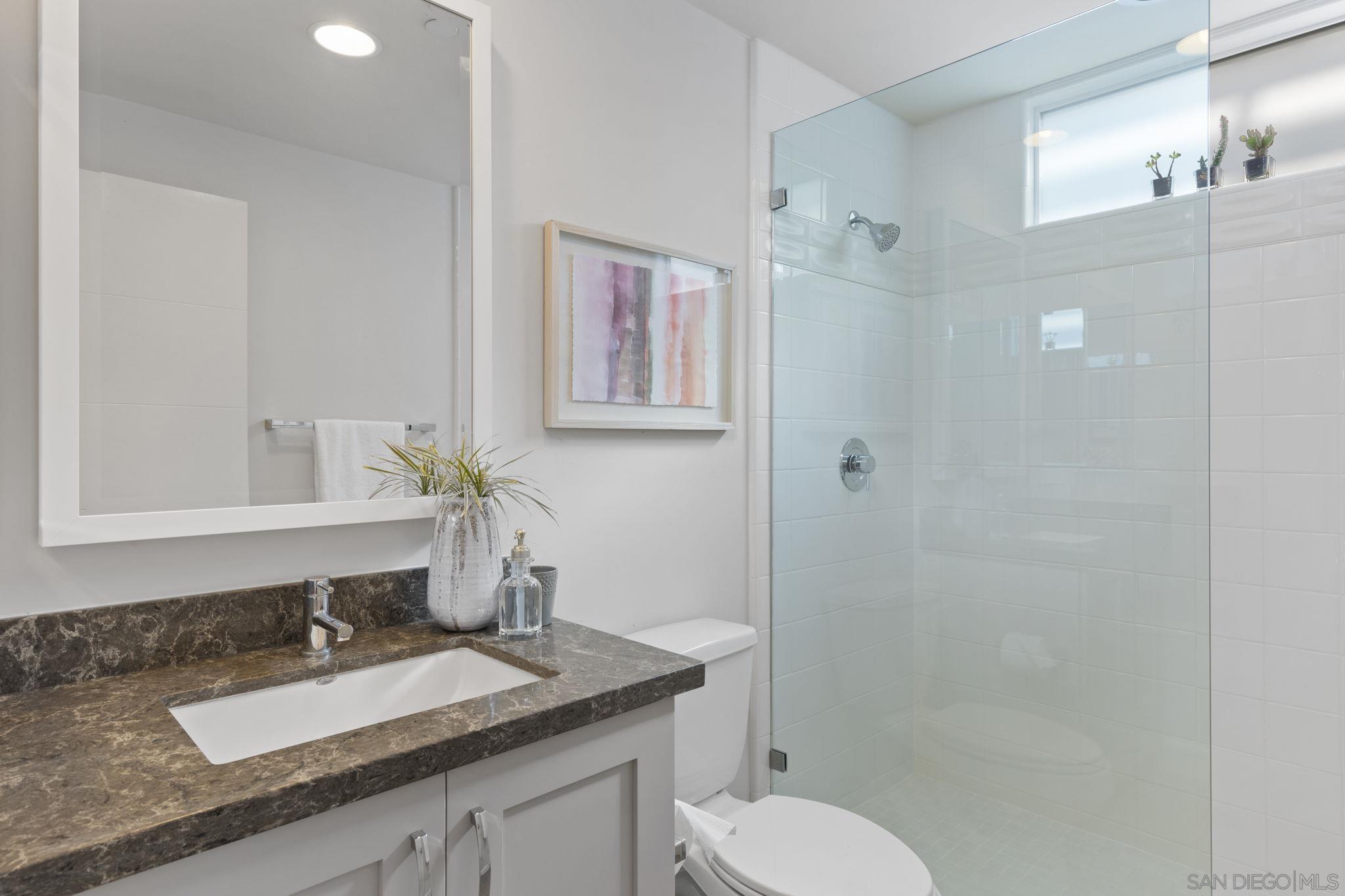2521 Ate Street Carlsbad, CA 92008 - Photo 13 of 30 a bathroom with a granite countertop sink toilet and shower