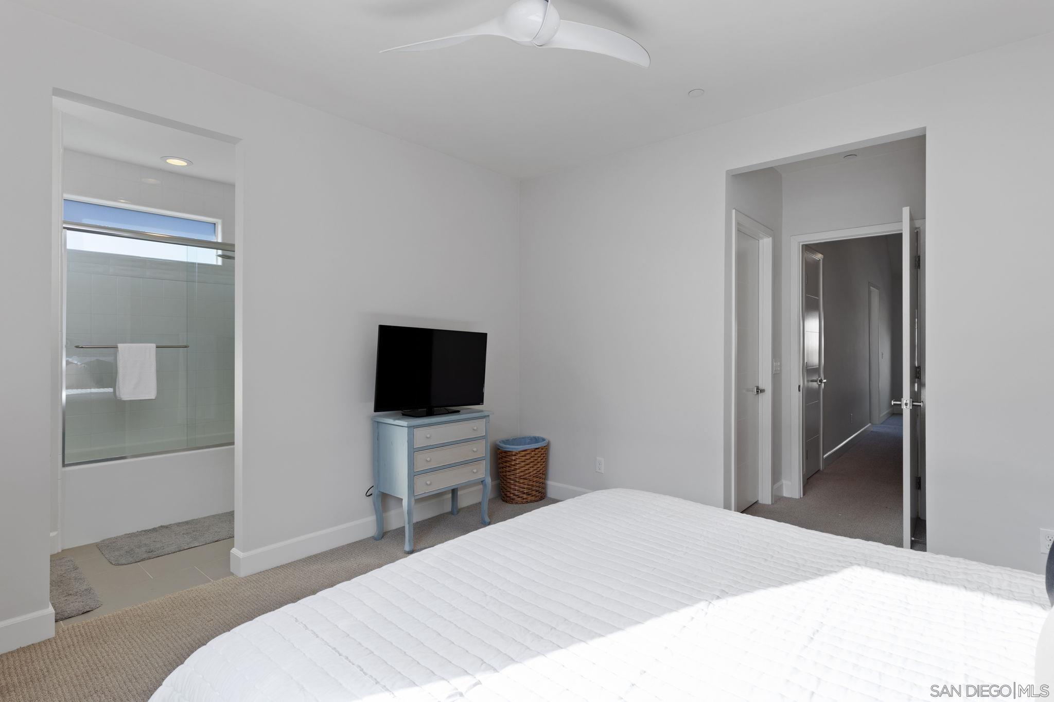 2521 Ate Street Carlsbad, CA 92008 - Photo 15 of 30 a bedroom with a bed and a flat tv screen on wall