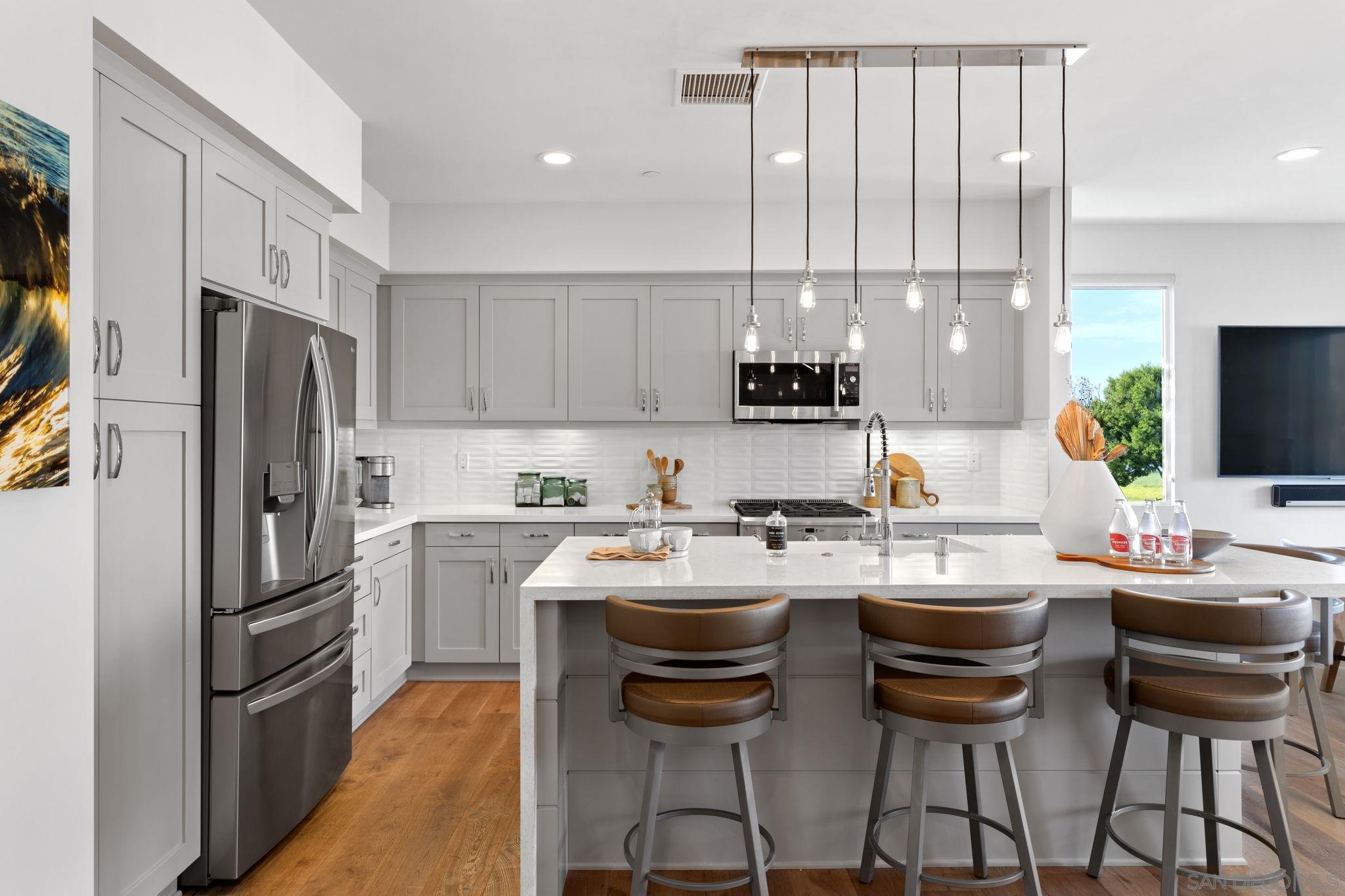 2521 Ate Street Carlsbad, CA 92008 - Photo 16 of 30 a kitchen with appliances a sink cabinets and a counter top space
