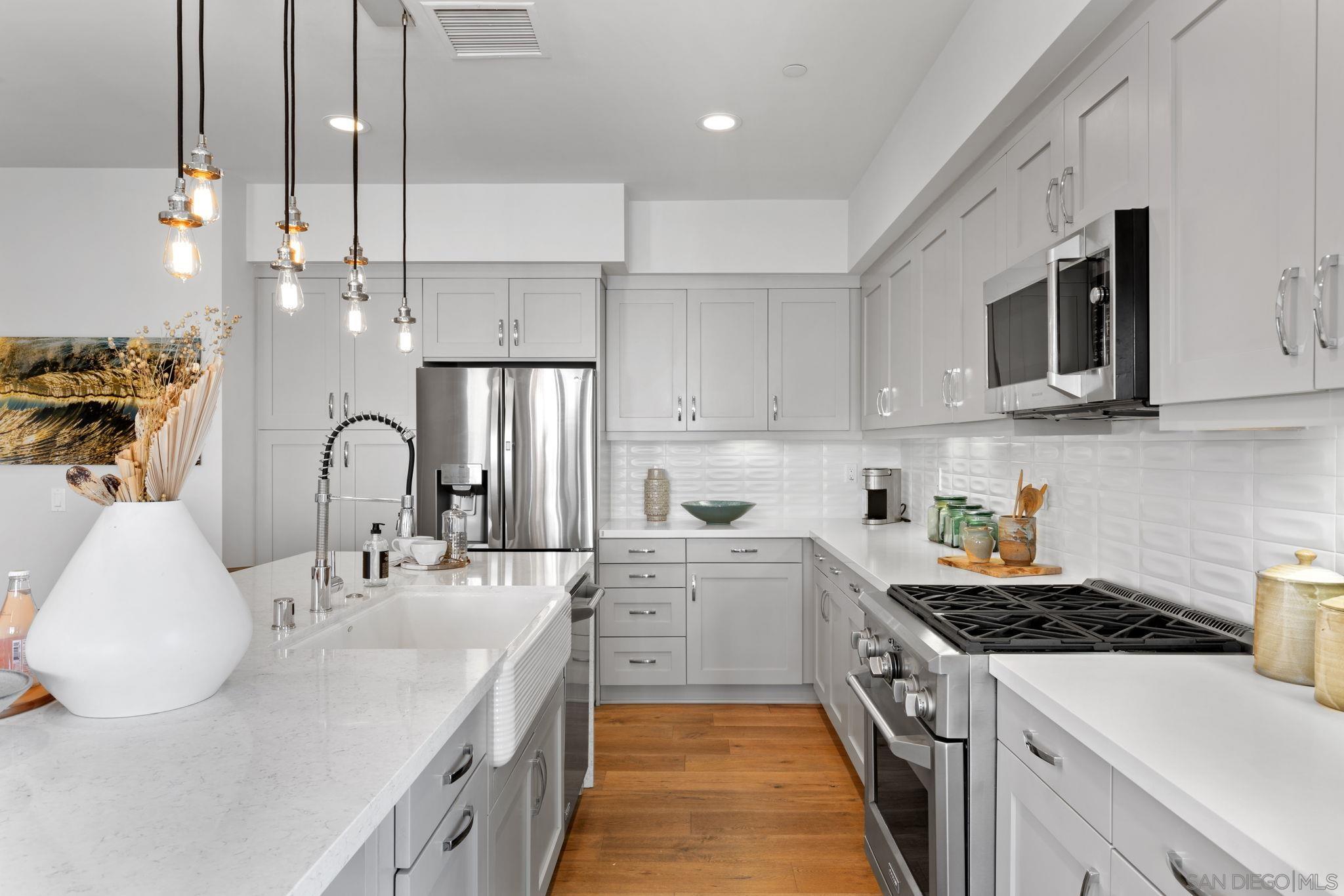 2521 Ate Street Carlsbad, CA 92008 - Photo 17 of 30 a kitchen with stainless steel appliances granite countertop a sink a stove and a refrigerator