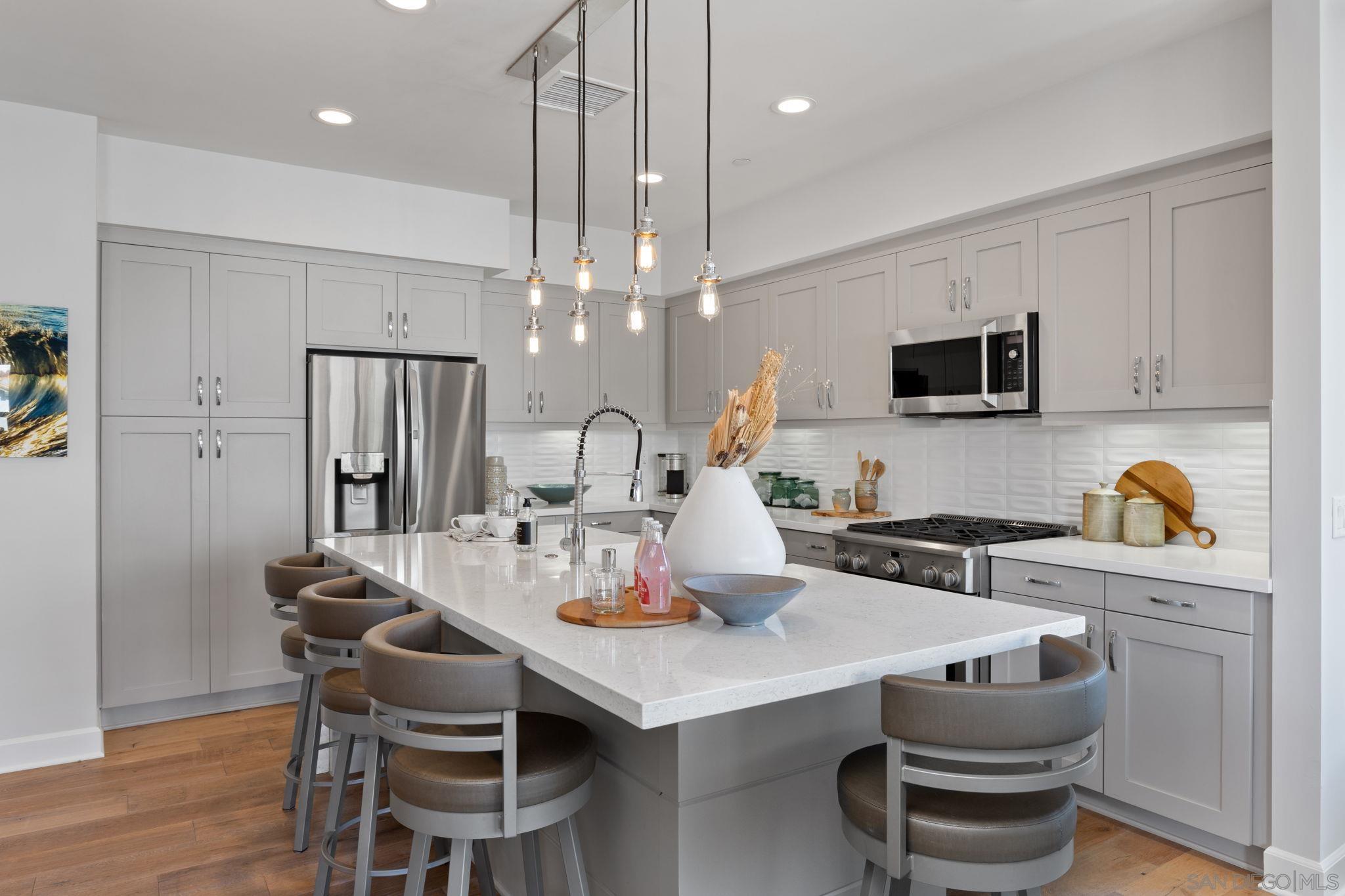 2521 Ate Street Carlsbad, CA 92008 - Photo 18 of 30 a kitchen with a dining table and chairs