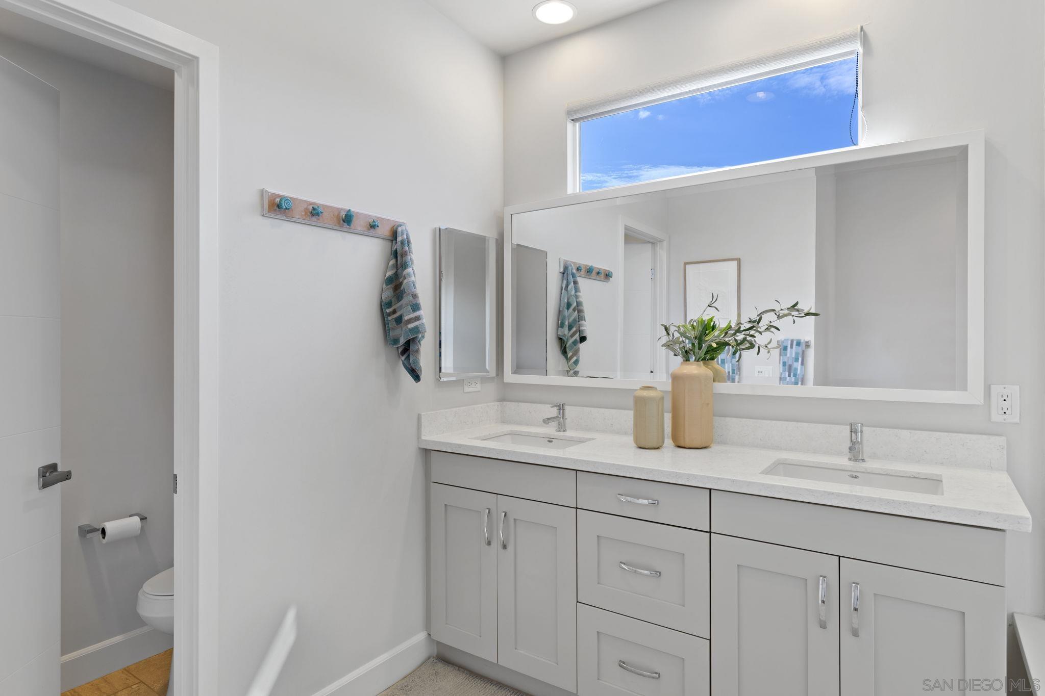 2521 Ate Street Carlsbad, CA 92008 - Photo 22 of 30 a bathroom with a granite countertop sink and a mirror