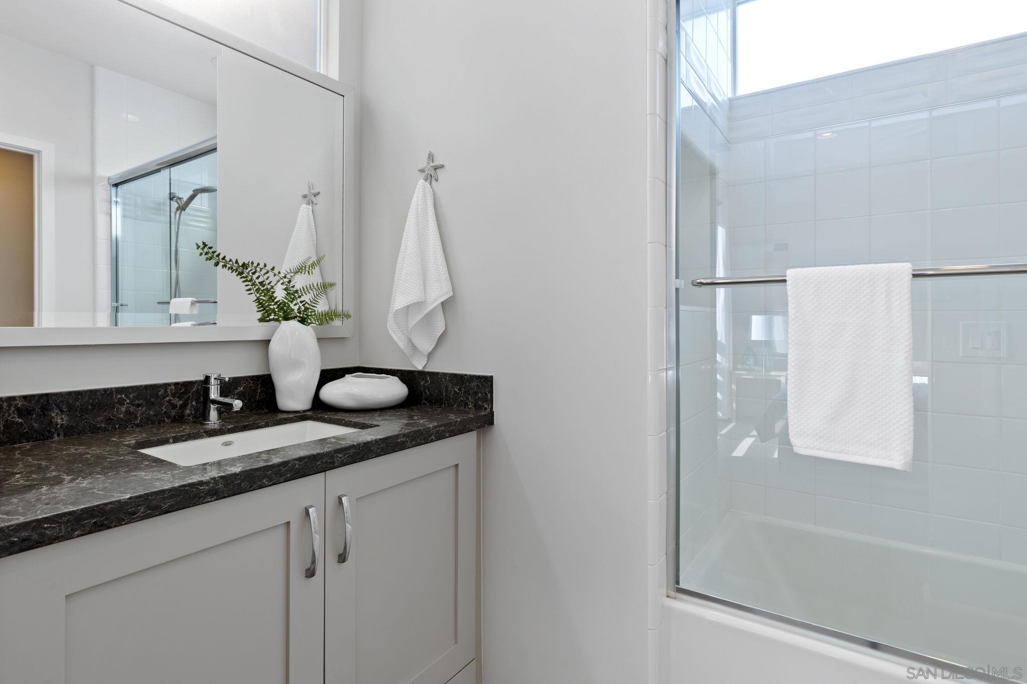 2521 Ate Street Carlsbad, CA 92008 - Photo 30 of 30 a bathroom with a granite countertop sink and a mirror
