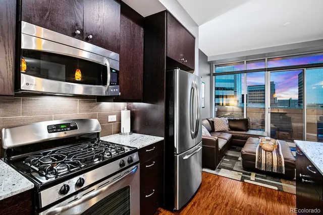 a kitchen with stainless steel appliances kitchen island granite countertop a sink and cabinets