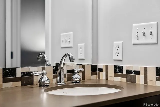 a bathroom with a double vanity sink a toilet and a mirror