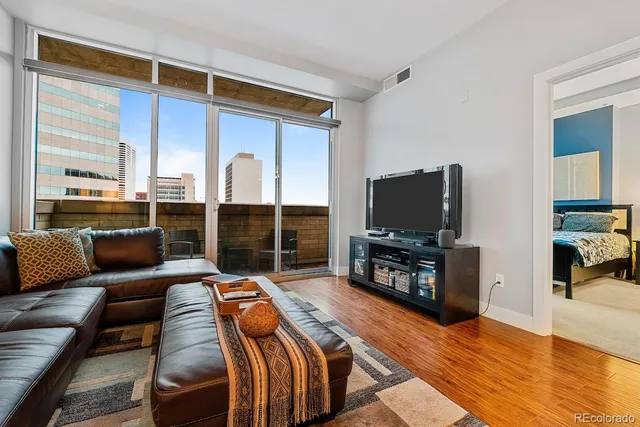 a view of a kitchen with a sink and large windows