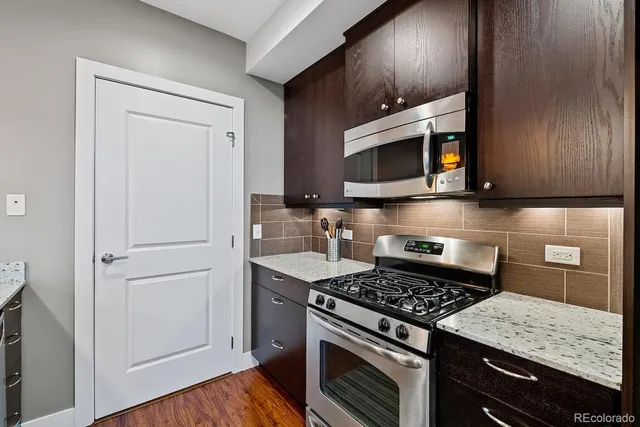 a view of kitchen with sink refrigerator and stove