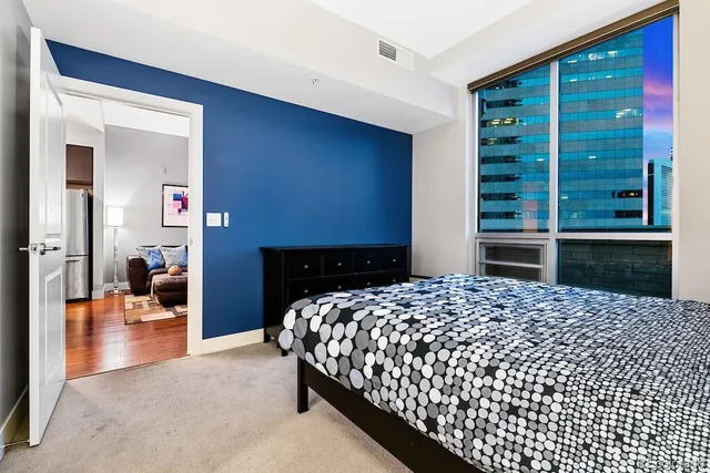 a bedroom with a bed and window