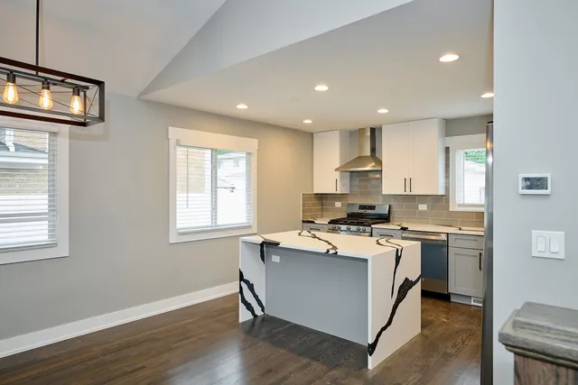 a kitchen with a stove a sink and a refrigerator