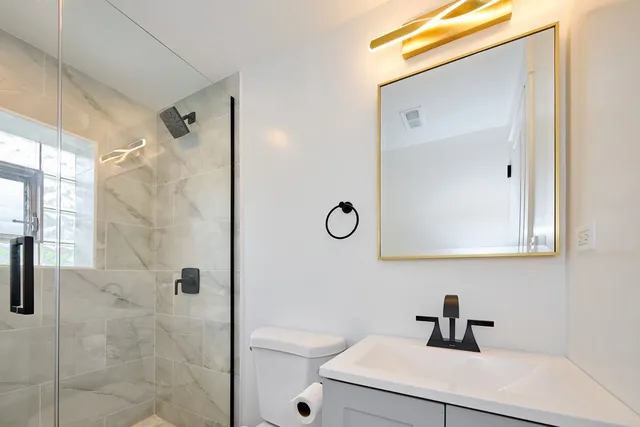 a bathroom with a shower and mirror