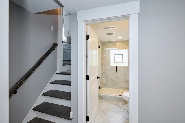 a bathroom with a glass shower door and a bathtub