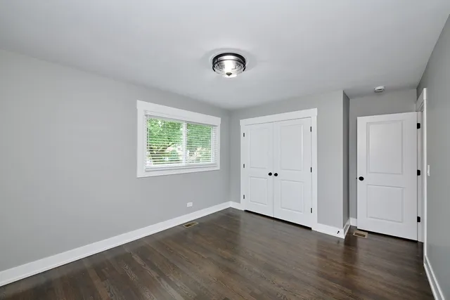 a view of a room with wooden floor and windows