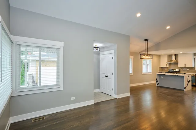 a large kitchen with stainless steel appliances granite countertop a refrigerator and a stove top oven