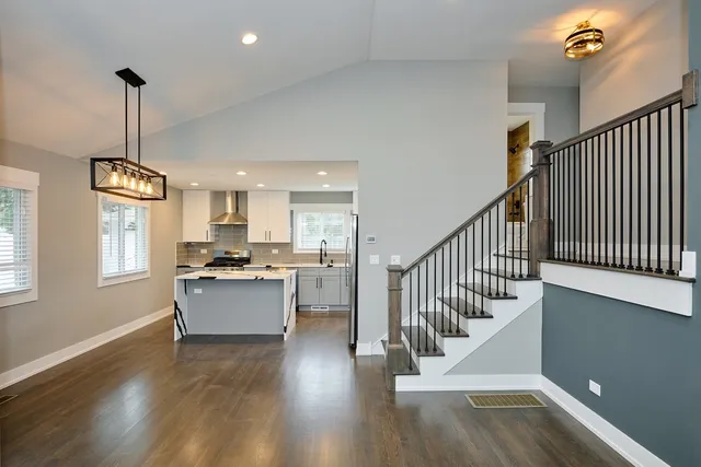 a view of entryway and kitchen with wooden floor