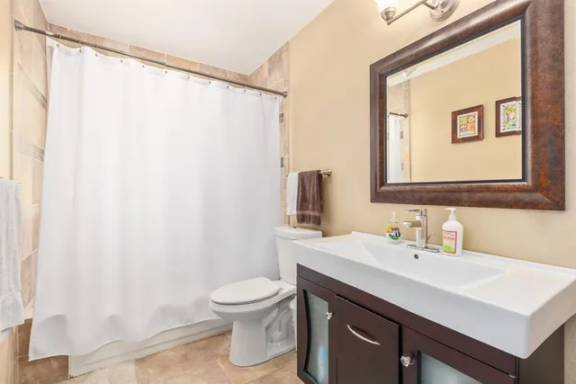 a bathroom with a sink a toilet and a mirror