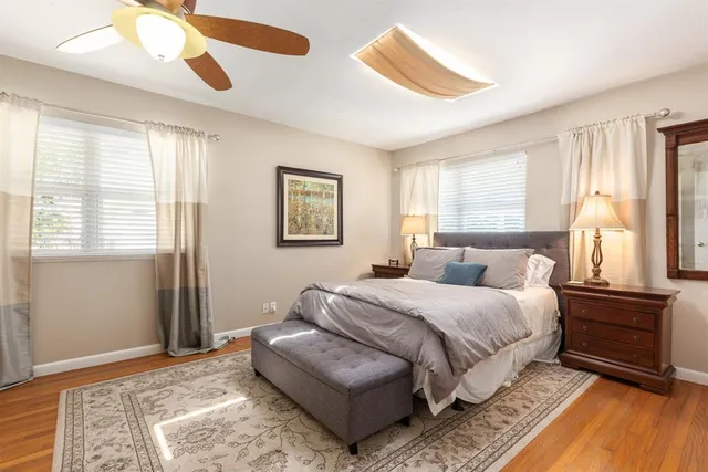 a bedroom with a bed lamp and a window