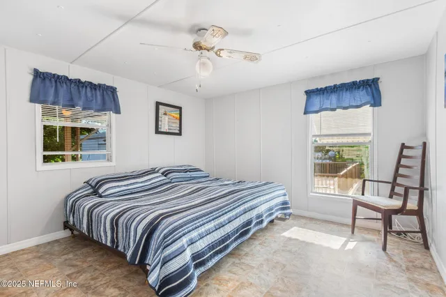 a view of a room with wooden floor and floor to ceiling window