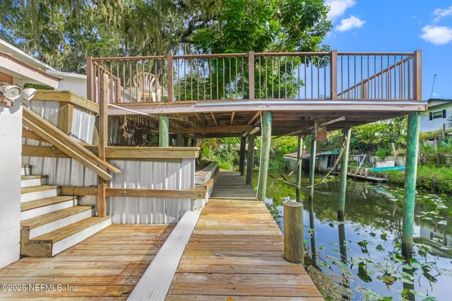 a view of house with swimming pool and porch