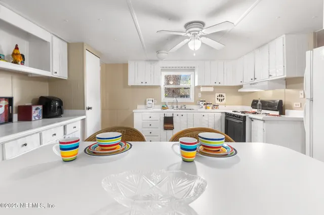 a kitchen with cabinets appliances a sink and a counter top space