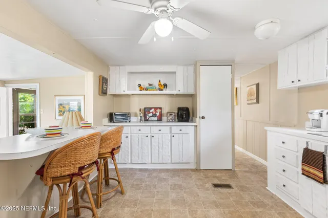 a kitchen with stainless steel appliances a stove a refrigerator and a chandelier