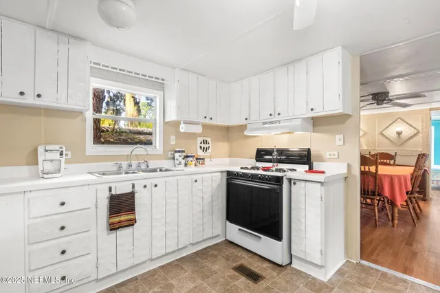a view of a hallway with wooden floor and dining room view