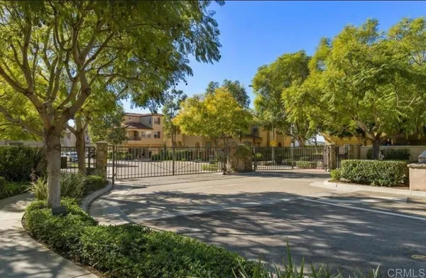 a street sign on a wall next to a road