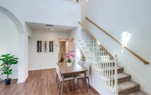 a view of a dining room with furniture and wooden floor