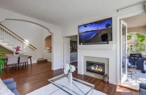 a living room with furniture fireplace and window