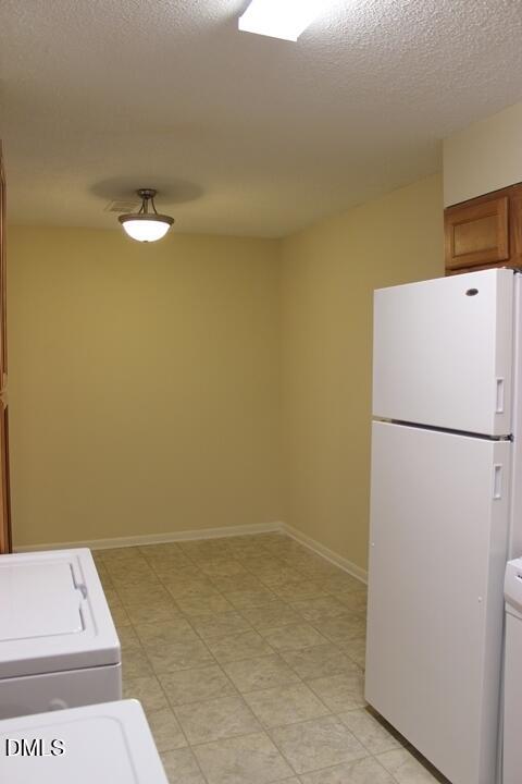 203 East Ransom Street, Unit 3D Fuquay-Varina, NC 27526 - Photo 3 of 10 a view of a storage & utility room with a refrigerator