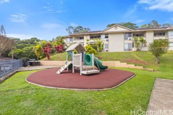 a view of a house with a swimming pool and a yard