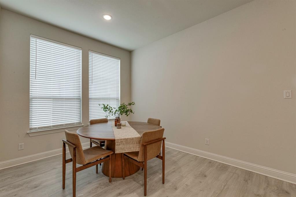 9613 Boulder Pt Road Oak Point, TX 75068 - Photo 10 of 28 Dining area featuring light wood-finish flooring, neutral wall tones, two large windows with blinds, and recessed lighting