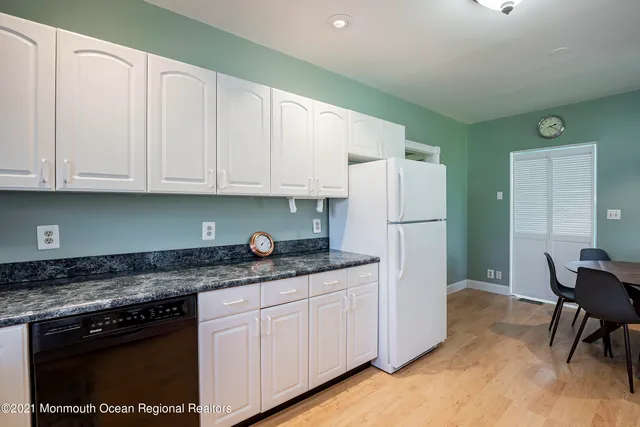 a view of a patio with wooden floor chairs