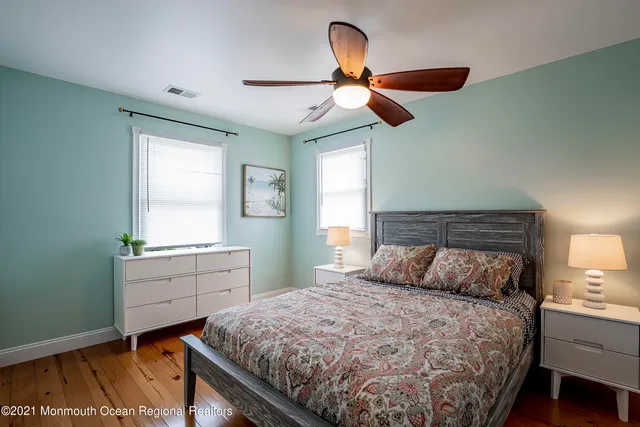 a bedroom with two beds and a window