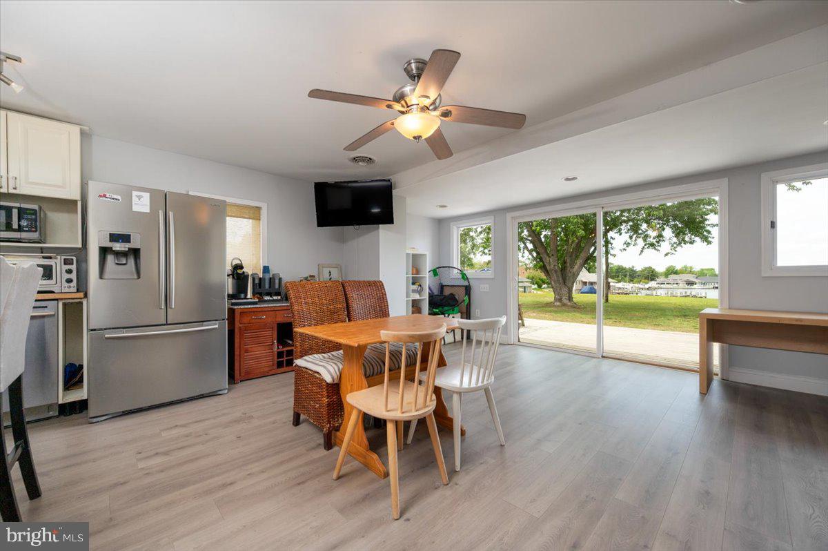 1312 Tuggies Road Pasadena, MD 21122 - Photo 13 of 75 a view of a dining room with furniture window and wooden floor
