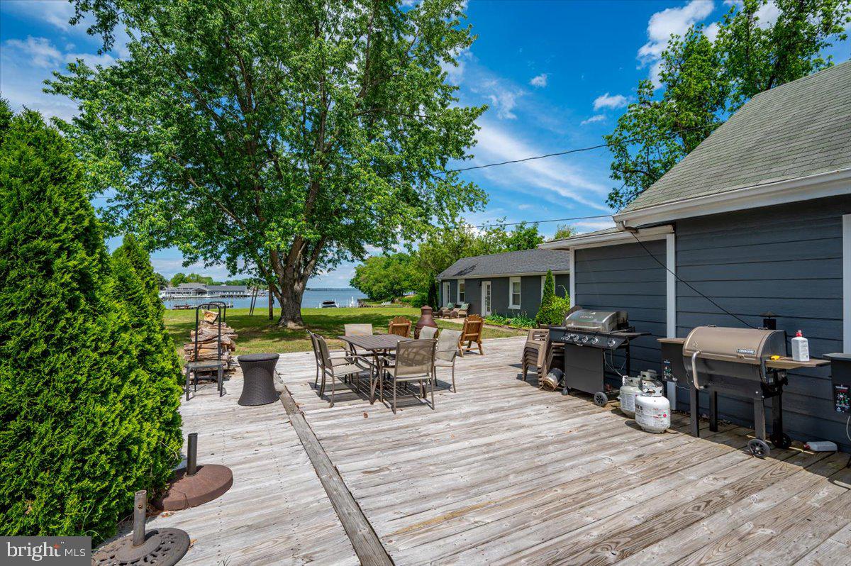 1312 Tuggies Road Pasadena, MD 21122 - Photo 15 of 75 a view of backyard with seating space and trees in the background