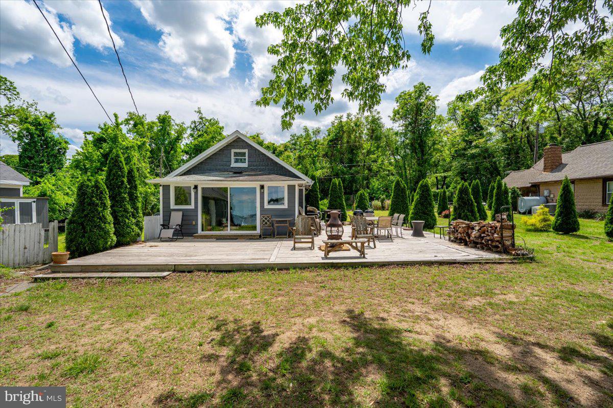 1312 Tuggies Road Pasadena, MD 21122 - Photo 18 of 75 a view of swimming pool with lawn chairs and plants