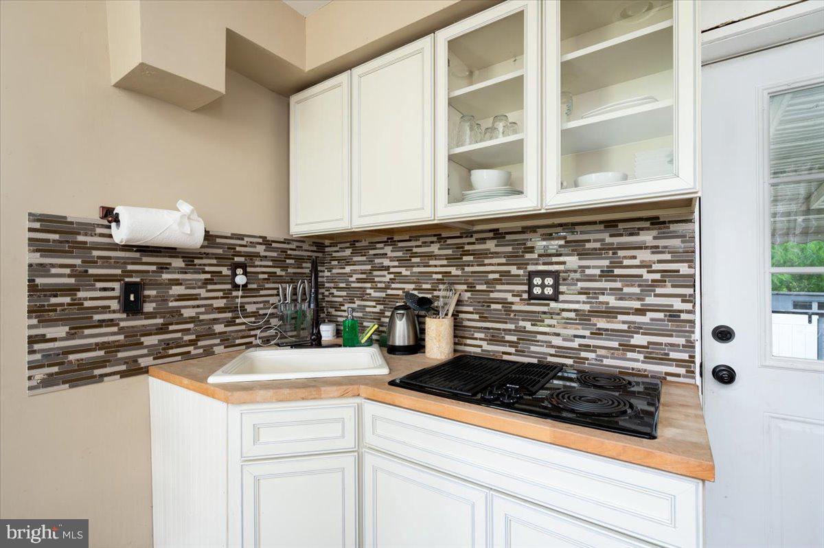 1312 Tuggies Road Pasadena, MD 21122 - Photo 27 of 75 a kitchen with a stove and a white cabinets