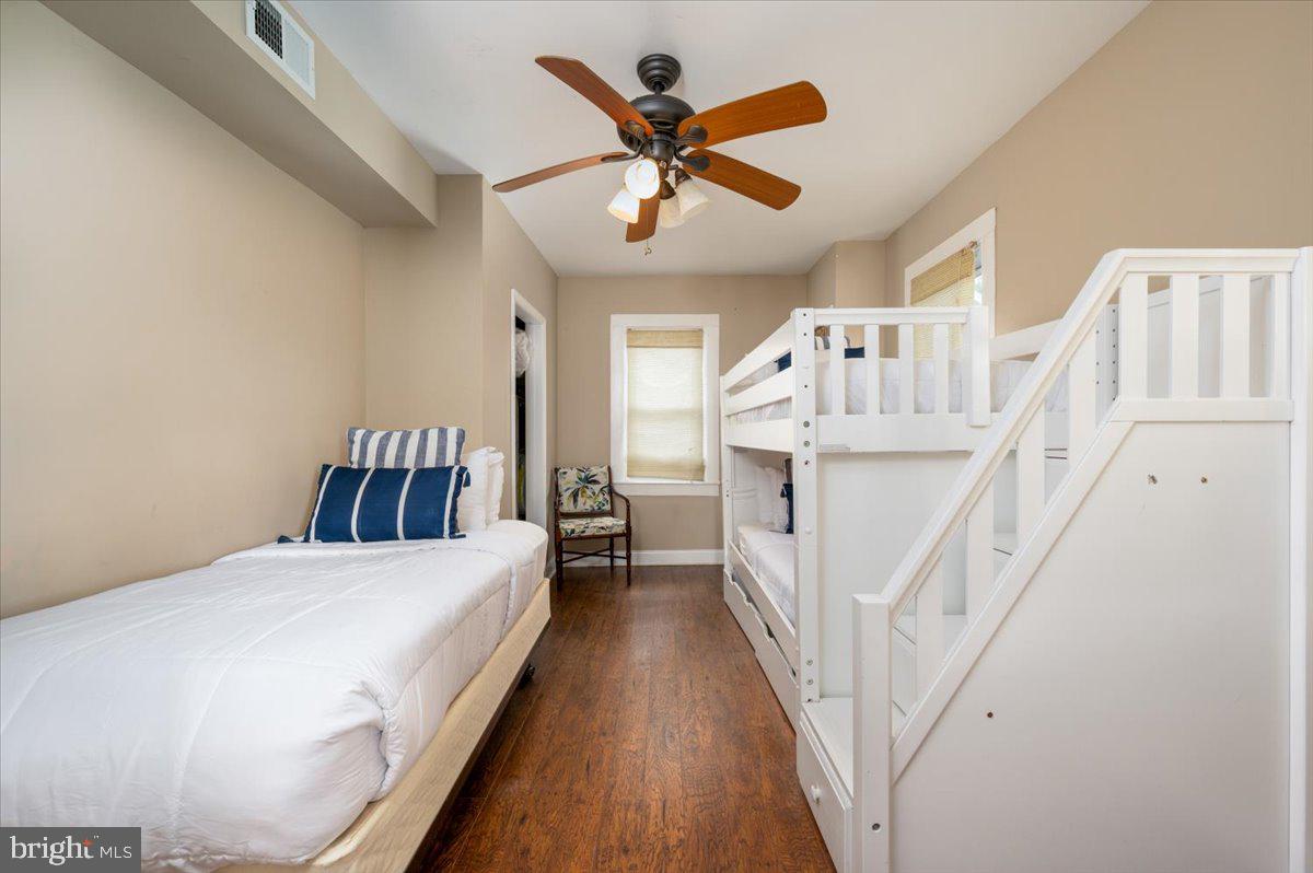 1312 Tuggies Road Pasadena, MD 21122 - Photo 32 of 75 a bed room with a bed and a chandelier