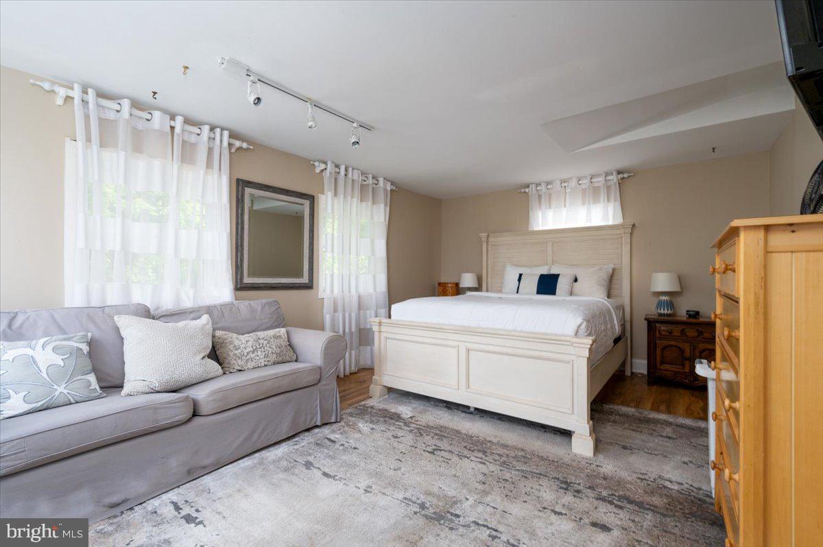 1312 Tuggies Road Pasadena, MD 21122 - Photo 35 of 75 a spacious bedroom with a bed and a couch