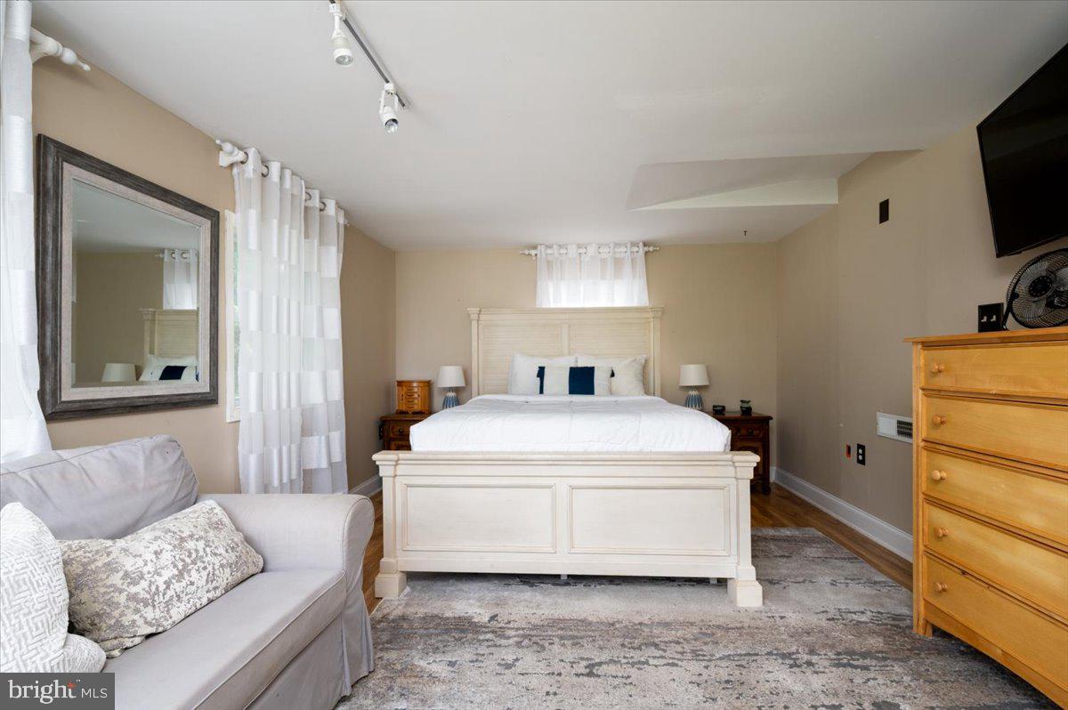 1312 Tuggies Road Pasadena, MD 21122 - Photo 36 of 75 a bedroom with a bed and a flat screen tv