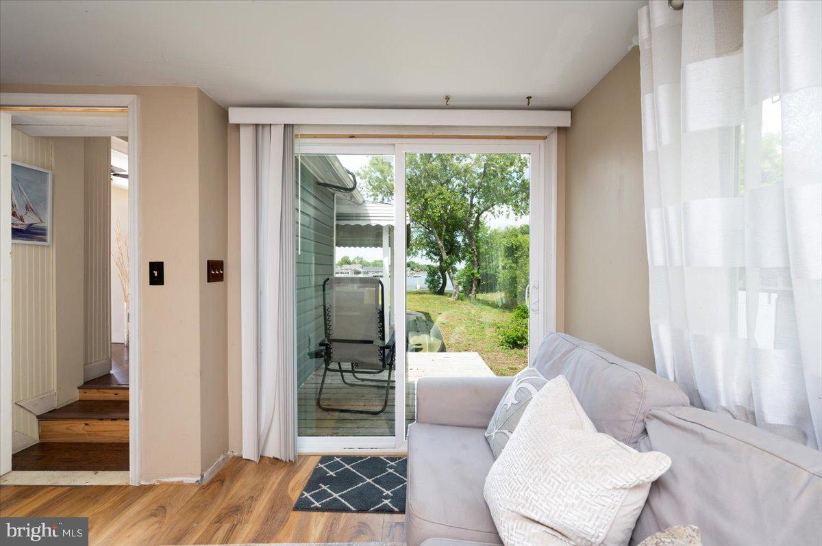 1312 Tuggies Road Pasadena, MD 21122 - Photo 38 of 75 a living room with furniture and a floor to ceiling window
